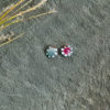 BACk of White with dark pink enameled flower earrings_