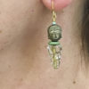 brass head buddha earrings on ear model